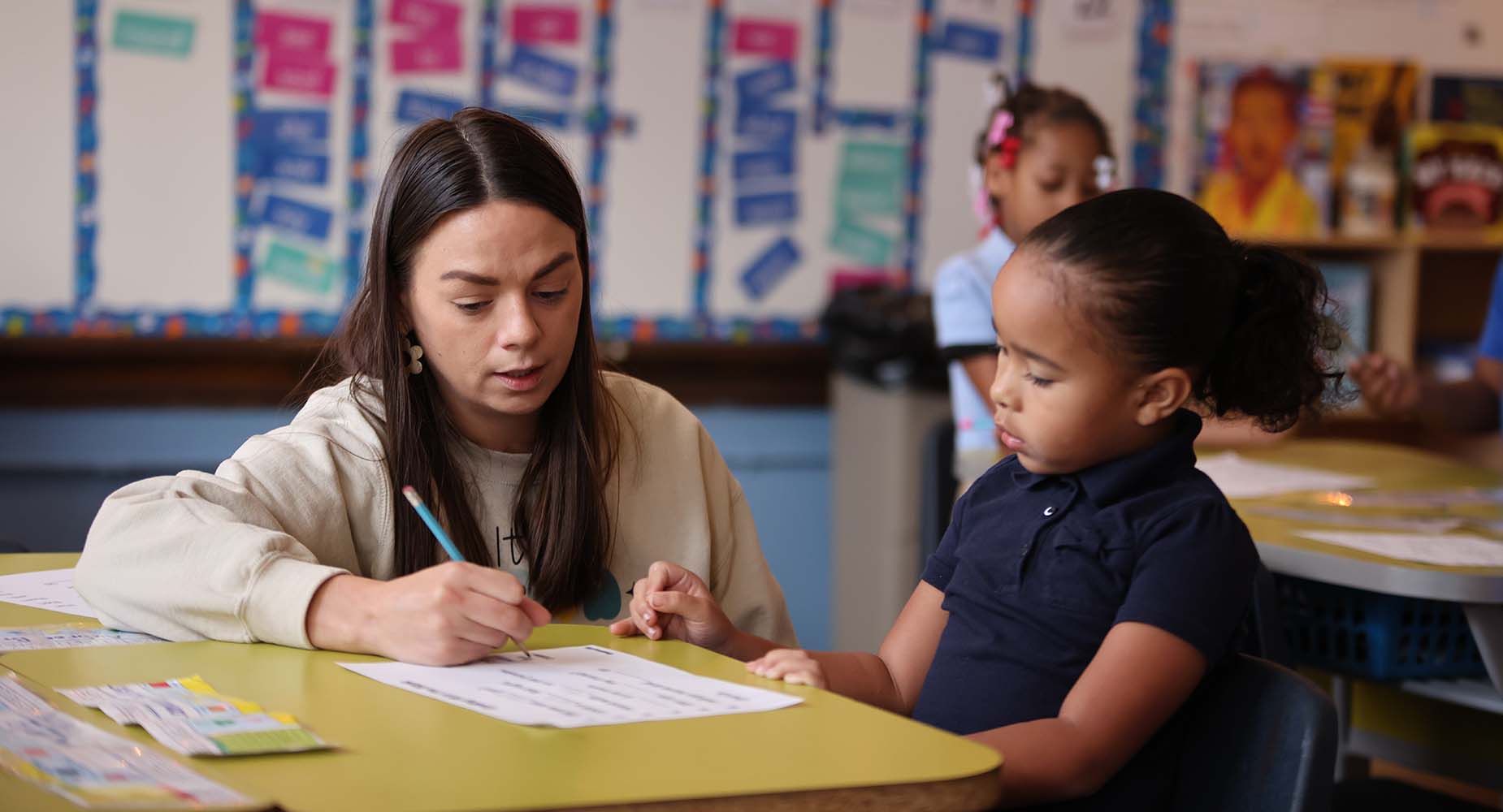 Teacher helping student